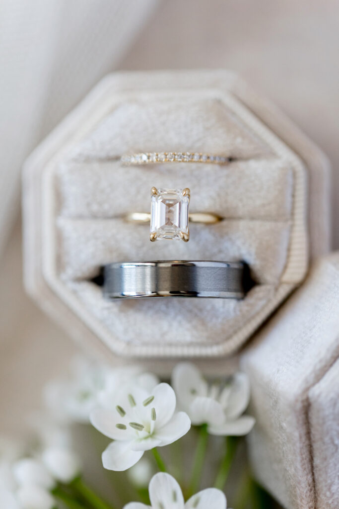 Wedding rings in cream box, both bride's and groom's.