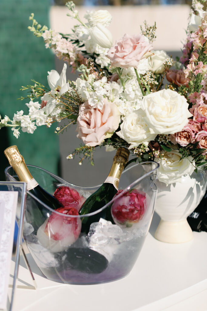 Bar top floral arrangement of white and pink flowers.