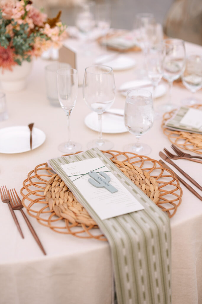 Wedding reception table place settings at round table.