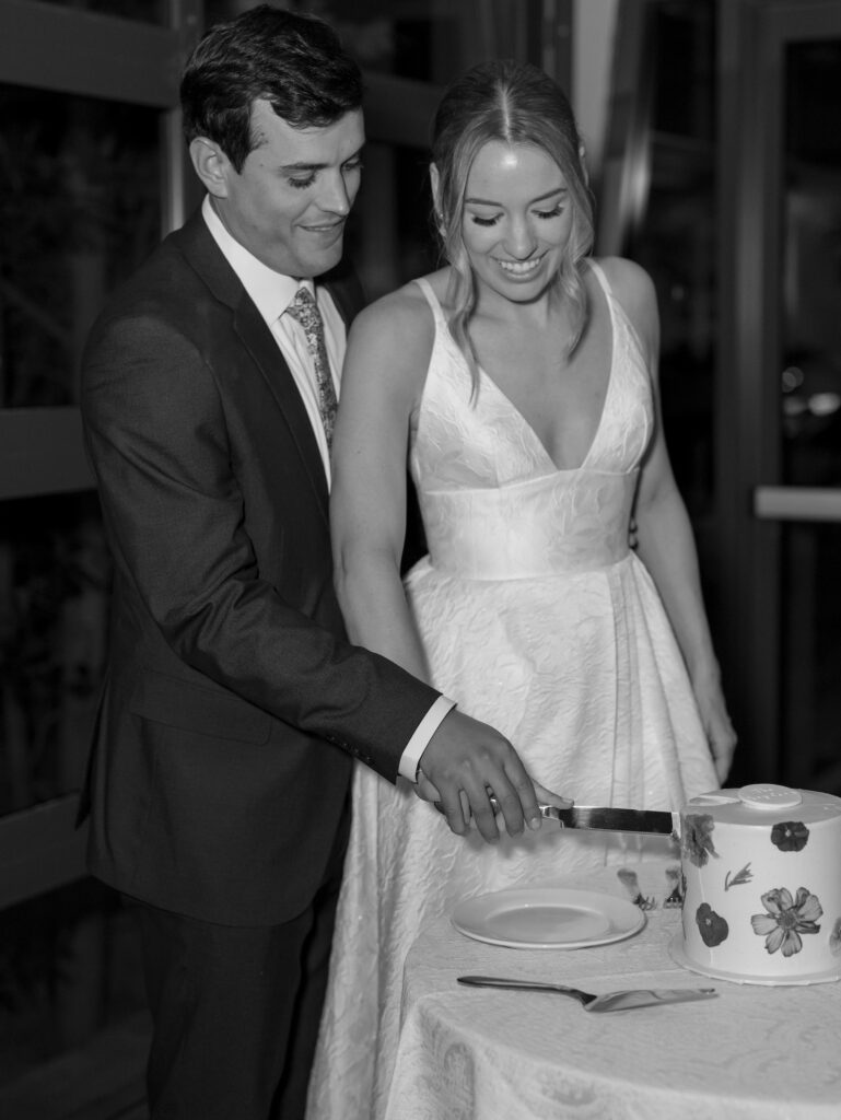 Bride and groom cutting the cake at wedding.