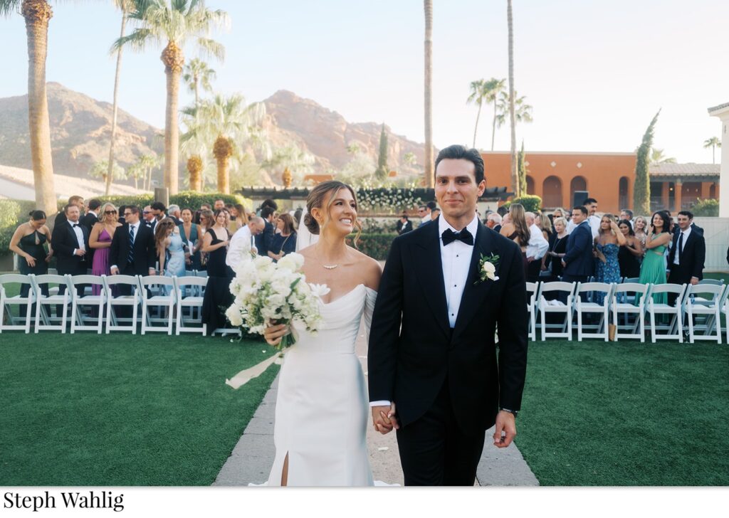 Bride and groom exiting wedding ceremony aisle at Omni Resort.