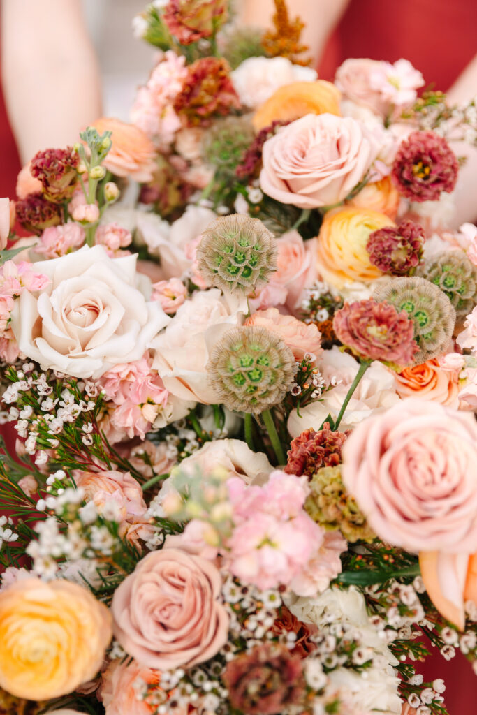 Wedding bouquets of pink, orange, and burgundy colors.