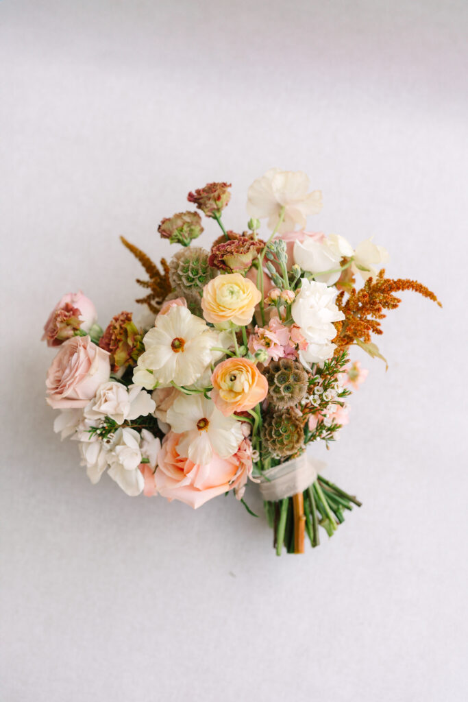 Wedding bridal bouquet of sunset colors flowers.