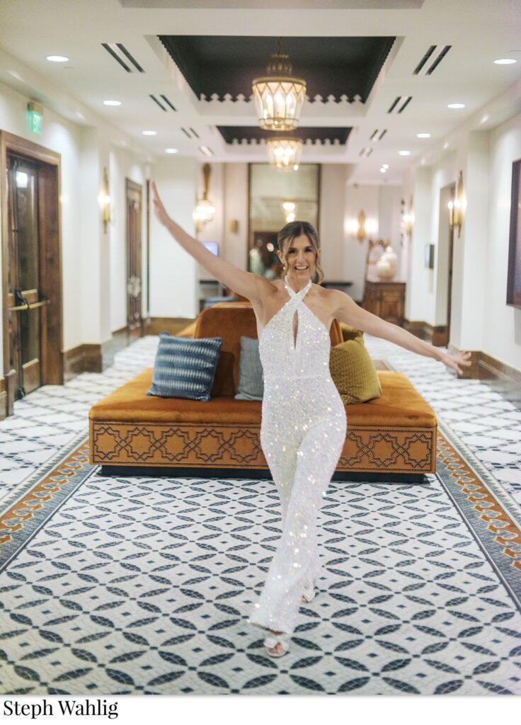 Bride in sequin pant suit posing inside.
