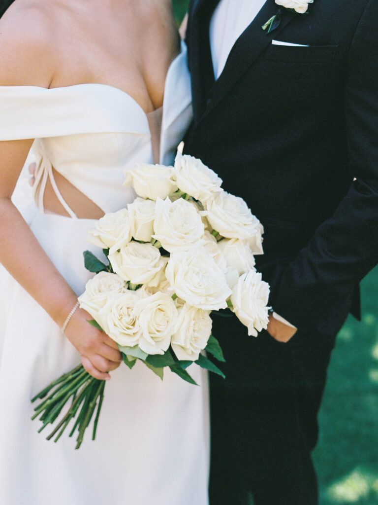 Bridal bouquet of white long stem roses.