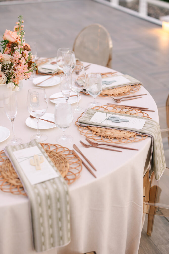Wedding reception table place settings at round table.