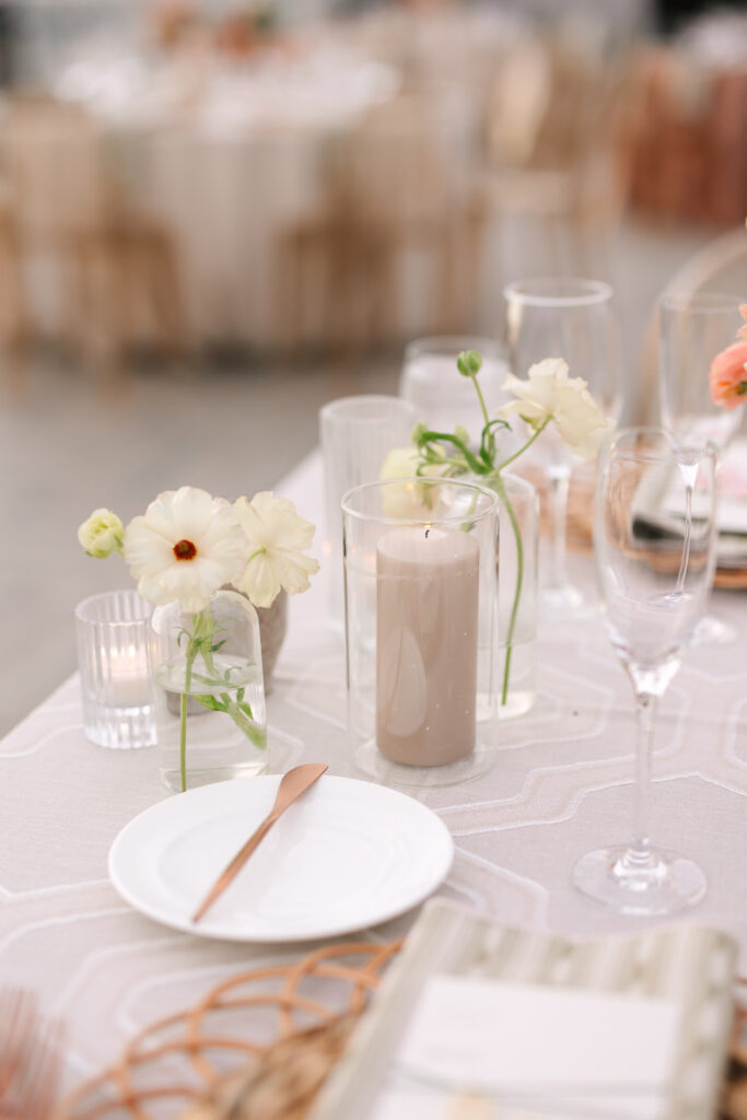 Wedding reception decor of pillar candles and bud vases.