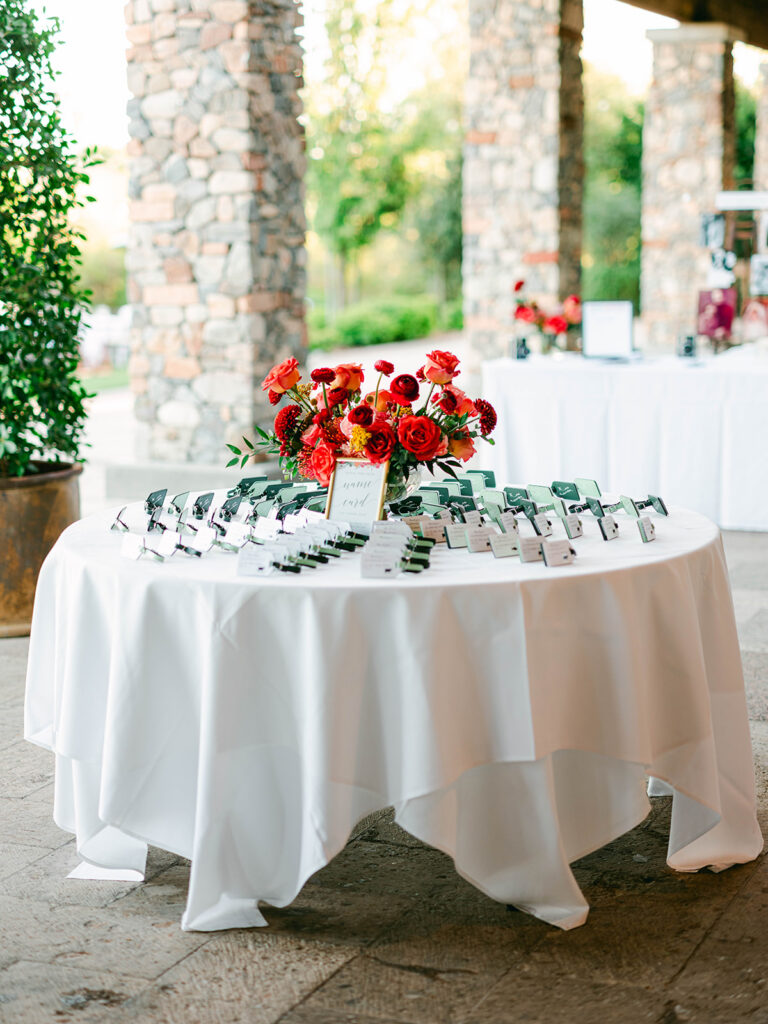 Wedding guest escort card table with floral centerpiece in center.
